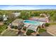 Aerial view of the community pool and tennis courts with scenic views of the lake at 8699 Garrison Ct, Arvada, CO 80005