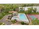 Aerial view of the community pool and clubhouse with lake views at 8699 Garrison Ct, Arvada, CO 80005