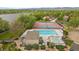 Aerial view of the community pool and tennis courts with manicured landscape at 8699 Garrison Ct, Arvada, CO 80005
