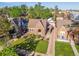 An aerial view of a well-maintained brick home with lush landscaping and a brick driveway at 1528 Holly St, Denver, CO 80220