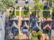 Aerial view of neighborhood with houses, mature trees, and solar panels on multiple roofs at 1528 Holly St, Denver, CO 80220