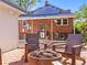 Backyard patio area with fire pit and solar panels on the roof of a brick house at 1528 Holly St, Denver, CO 80220