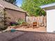 Backyard features a sand box, lounge furniture and colorful flower beds in brick enclosed area at 1528 Holly St, Denver, CO 80220