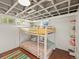 Finished basement bedroom area with a cozy bunk bed and natural light at 1528 Holly St, Denver, CO 80220