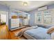 This bedroom features hardwood floors, large windows, and a closet with plenty of storage space at 1528 Holly St, Denver, CO 80220