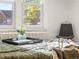 Bedroom close-up featuring a view of the window and a corner chair at 1528 Holly St, Denver, CO 80220