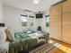 Sunlit bedroom with hardwood floors, large closet, and a cozy rug under the bed at 1528 Holly St, Denver, CO 80220