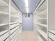 Walk-in closet with built-in shelving and drawers for organized storage at 1528 Holly St, Denver, CO 80220