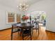 This dining area offers a view of the living space with lots of light, wood floors, and archway design at 1528 Holly St, Denver, CO 80220