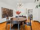 This dining room features hardwood floors, modern art, and a round table with seating for four at 1528 Holly St, Denver, CO 80220