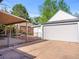 View of the detached garage, patio and privacy fence at 1528 Holly St, Denver, CO 80220