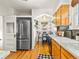 This kitchen features stainless steel appliances, a breakfast nook, and wood cabinets at 1528 Holly St, Denver, CO 80220