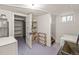 Clean laundry area with shelving, a utility sink, and a folding rack, plus washer and dryer at 1528 Holly St, Denver, CO 80220