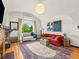 Inviting living room with arched window, hardwood floors, and stylish decor at 1528 Holly St, Denver, CO 80220