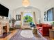 Bright living room featuring a large arched window and a cozy fireplace at 1528 Holly St, Denver, CO 80220
