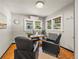 This office features hardwood floors, large windows, and a wooden desk with a computer at 1528 Holly St, Denver, CO 80220