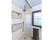 Modern shower with sleek fixtures, tiled walls, and built-in storage niches at 1528 Holly St, Denver, CO 80220