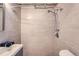 Modern bathroom featuring tiled walls and a shower, providing a clean and updated space at 700 E Ellsworth Ave # 2, Denver, CO 80209