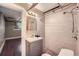 Cozy bathroom featuring tiled walls, a shower, and modern fixtures, designed for comfort and convenience at 700 E Ellsworth Ave # 2, Denver, CO 80209
