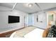 Cozy bedroom featuring hardwood floors, exposed plumbing, and neutral walls, offering a blank canvas for customization at 700 E Ellsworth Ave # 2, Denver, CO 80209