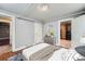 Functional bedroom with hardwood floors, neutral walls, and a view into the kitchen, creating a comfortable living space at 700 E Ellsworth Ave # 2, Denver, CO 80209