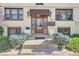 Inviting front entrance with a covered porch, diamond pane windows, and meticulously maintained landscaping at 700 E Ellsworth Ave # 2, Denver, CO 80209