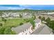 Aerial view of townhomes in a suburban community near open fields and distant mountain views at 1464 Nemrick Pl, Castle Rock, CO 80109