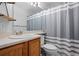 Bathroom with oak vanity and combination shower/tub at 1464 Nemrick Pl, Castle Rock, CO 80109