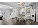 Bright dining room featuring a ceiling fan, wood floors, and a lovely view to the main level entry at 1464 Nemrick Pl, Castle Rock, CO 80109