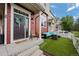 Inviting front porch with seating and artificial grass provides a relaxing outdoor space at 1464 Nemrick Pl, Castle Rock, CO 80109
