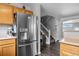 Kitchen with stainless steel refrigerator leading to stairs to the upper level at 1464 Nemrick Pl, Castle Rock, CO 80109