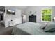 Well-lit bedroom featuring a large window, wall decor, and TV at 1464 Nemrick Pl, Castle Rock, CO 80109