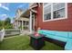 Inviting outdoor patio featuring a modern fire pit, cozy seating, and a well-manicured artificial lawn at 1464 Nemrick Pl, Castle Rock, CO 80109