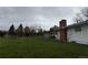 Large, private back yard with a lawn and a brick chimney at 8895 E Radcliff E Ave, Denver, CO 80237