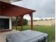 Spacious backyard features a charming pergola with string lights and a luxurious hot tub at 8895 E Radcliff E Ave, Denver, CO 80237
