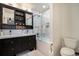 Modern bathroom features a double sink vanity, updated shower, and sleek finishes at 8895 E Radcliff E Ave, Denver, CO 80237