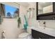 Bright bathroom featuring a modern vanity, updated fixtures, and a window with a view at 8895 E Radcliff E Ave, Denver, CO 80237