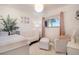 Cozy Bedroom with a white crib, comfortable seating, and soft, natural light at 8895 E Radcliff E Ave, Denver, CO 80237