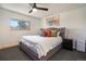 Stylish bedroom showcasing an upholstered headboard, soft linens, and plenty of natural light at 8895 E Radcliff E Ave, Denver, CO 80237