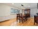 Elegant dining room with modern lighting, hardwood floors, and ample seating space at 8895 E Radcliff E Ave, Denver, CO 80237