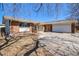 Single-story brick home featuring a two car garage and a concrete driveway at 8895 E Radcliff E Ave, Denver, CO 80237