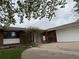 Image of front entrance to brick home with pergola and mature landscaping at 8895 E Radcliff E Ave, Denver, CO 80237
