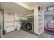 Efficient laundry room with shelving, new washer and dryer, and storage space at 8895 E Radcliff E Ave, Denver, CO 80237