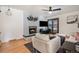 Comfortable living area featuring a fireplace, hardwood floors, and access to the backyard at 8895 E Radcliff E Ave, Denver, CO 80237