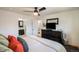 Spacious main bedroom with dark furniture, a ceiling fan, ensuite, and good natural lighting at 8895 E Radcliff E Ave, Denver, CO 80237