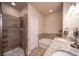 Bathroom featuring a double vanity, granite countertops, a soaking tub, and a separate tiled shower at 11250 Florence St # 17D, Commerce City, CO 80640