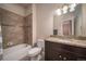 Neutral bathroom with a shower and tub combination and a granite sink at 11250 Florence St # 17D, Commerce City, CO 80640