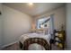 Bright bedroom features neutral tones, plush carpet, and a comfortable bed with a decorative pillow at 11250 Florence St # 17D, Commerce City, CO 80640