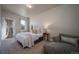 A bright bedroom features neutral tones, plush carpet, and a comfortable seating area, creating a serene retreat at 11250 Florence St # 17D, Commerce City, CO 80640
