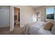 A tranquil bedroom offers a door to the outside, neutral tones, plush carpet, and plenty of natural light at 11250 Florence St # 17D, Commerce City, CO 80640